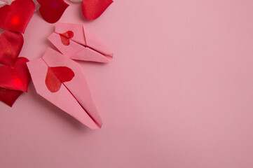two pink planes with red hearts on a pink background. valentine's day. wedding.