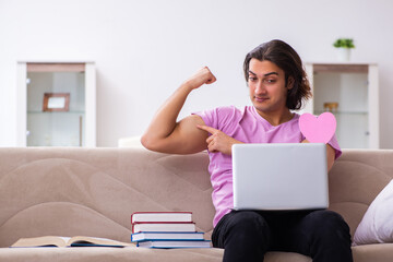Male student in love preparing for exams at home