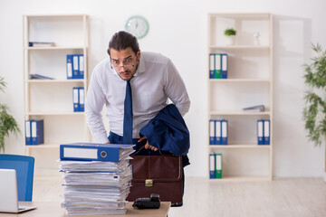 Young businessman unhappy with excessive work in the office