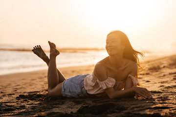 Fototapeta na wymiar Happy beach girl laughing smiling enjoying sunshine on summer vacation. Gorgeous beautiful young Chinese woman having fun.