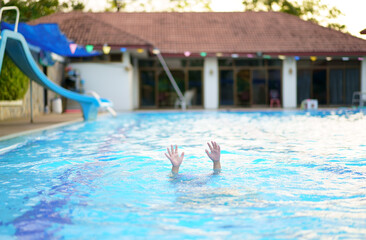 drowning child or kid and people cannot swim to deep water and raise two hand for help on swimming pool and near death