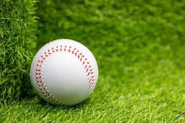 Obraz na płótnie Canvas Baseball is on green grass