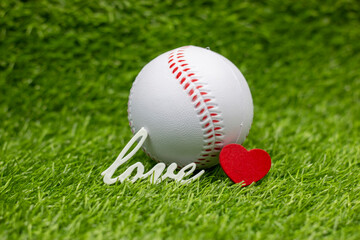 Baseball with love word  are on green grass