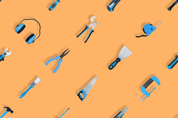 Tools seamless pattern. Various construction tools on an orange background.