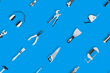 Tools seamless pattern. Various construction tools on a blue background.