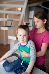 sister helping brother get ready