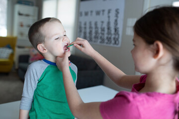 sister helps little brother