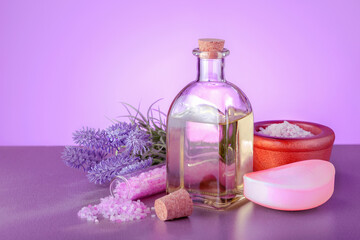 Obraz na płótnie Canvas Spa setting with natural oil, soap, sea salt and lavender flowers.