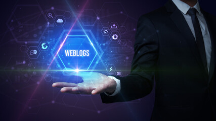 Man hand holding WEBLOGS inscription, social media concept