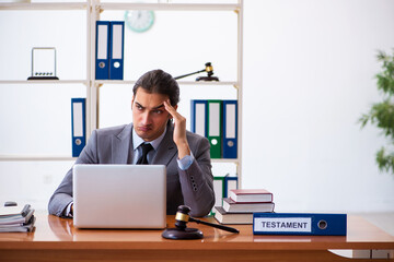 Young male lawyer sitting in the office