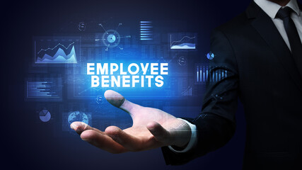 Hand of Businessman holding EMPLOYEE BENEFITS inscription, business success concept