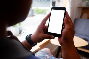 Mockup picture of business man's hands holding smart phone with white blank screen in modern place.