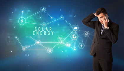 Businessman in front of cloud service icons with SOLAR ENERGY inscription, modern technology concept