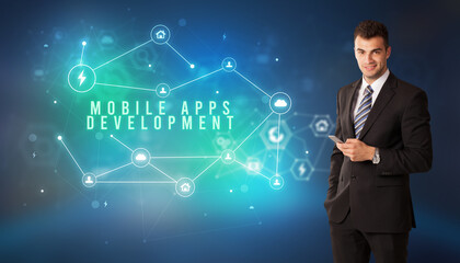Businessman in front of cloud service icons with MOBILE APPS DEVELOPMENT inscription, modern technology concept