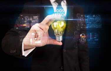 Businessman holding lightbulb with DDOS ATTACK inscription, online security idea concept