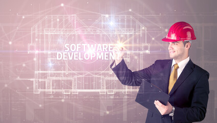 Handsome architect with helmet drawing SOFTWARE DEVELOPMENT inscription, new technology concept