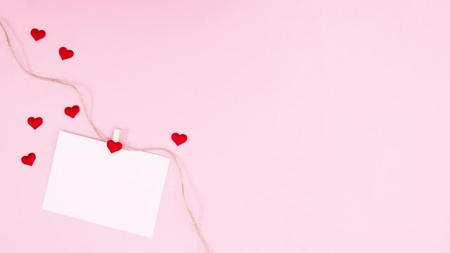 paper for text with hearts hooked on rope moving. Stop motion valentine day