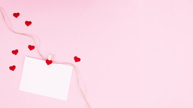 Paper for text hooking on rope with romantic hearts for valentine day. Stop motion