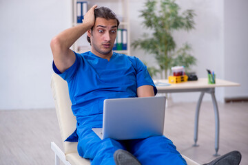 Young male doctor in telemedicine concept