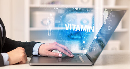 Doctor working a health check with VITAMIN inscription, recording medical test results