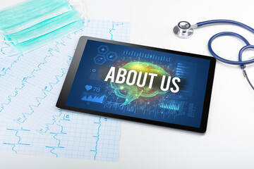 Tablet pc and medical tools with ABOUT US inscription, social distancing concept