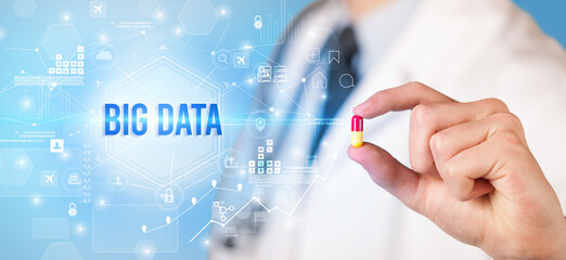 Doctor giving a pill with BIG DATA inscription, new technology solution concept