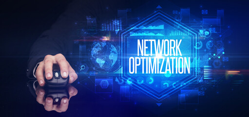 hand holding wireless peripheral with NETWORK OPTIMIZATION inscription, cyber security concept