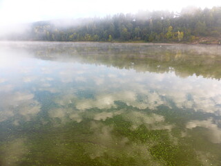 Algae and clouds in the Volga River. And there's a fog over the river