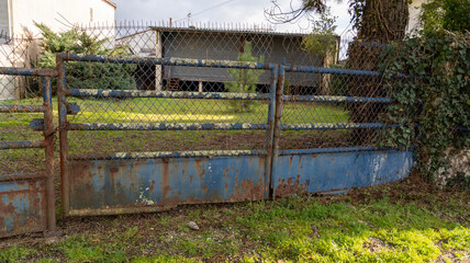 old retro rusty sttel portal of dirty used house access door garden