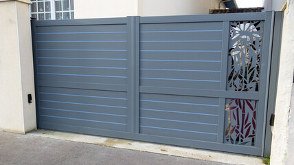 Fototapeta premium modern grey gate aluminum home portal gray door suburban house in street view