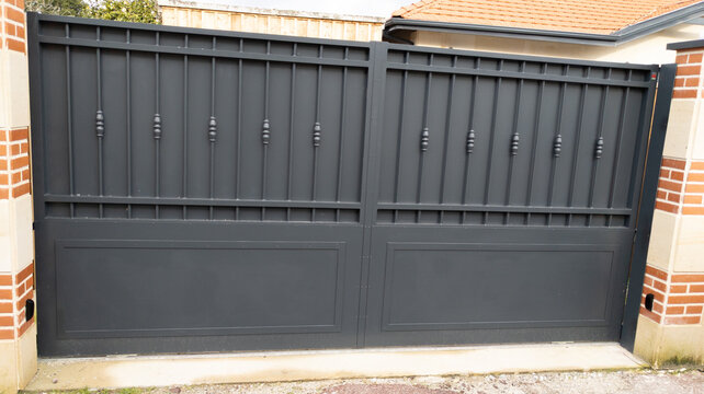 classic gray door metal home gate of car entrance of house garden