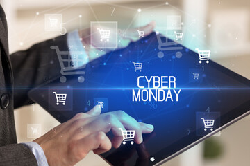 Young person makes a purchase through online shopping application with CYBER MONDAY inscription