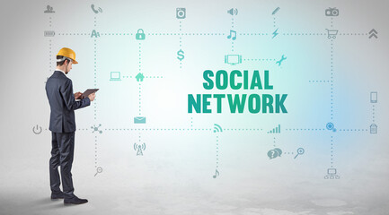 Engineer working on a new social media platform with SOCIAL NETWORK inscription concept