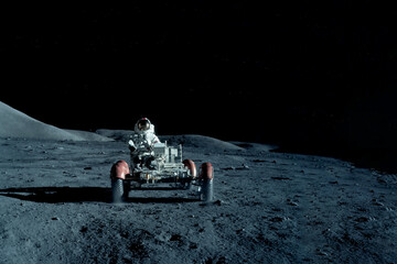 Astronaut near the moon rover on the moon. With land on the horizon. Elements of this image were...