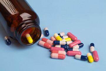 Various medicine capsules and bottle of pills