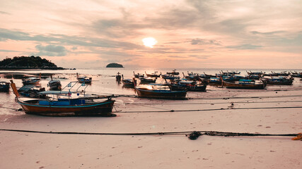 A wooden boat on the beach in the morning
