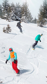 Active snowboarders riding on slope. Snowboarding closeup. Sheregesh ski resort