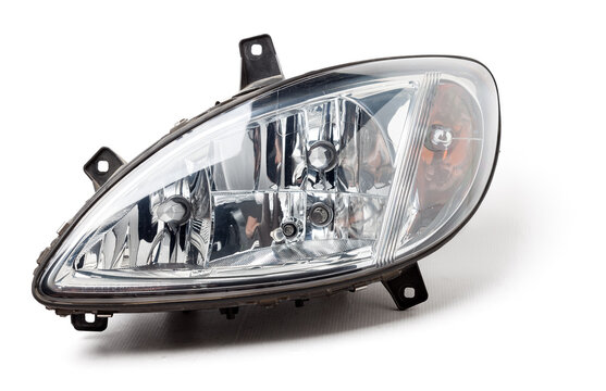 Stylish xenon headlight of a German car - optical equipment with a lamp inside on a white isolated background. Spare part for auto repair in a car workshop.