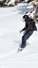 Fototapeta na wymiar Active man snowboarder riding on slope. Snowboarding closeup. Sheregesh ski resort