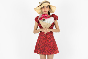 Attractive young Asian woman in red dress holding bouquet of flowers over white isolated background. Love and Valentines day