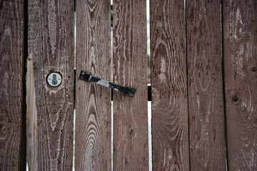 Old door, fence. The handle of the door. Wooden door. Background, texture.