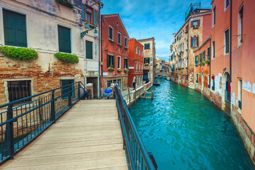 Fototapeta na wymiar Water canal with bridges and old buildings in Venice, Italy