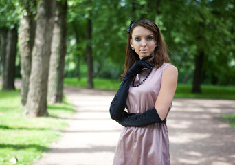 Portrait of a beautiful woman wearing vinatge outfit in summer park