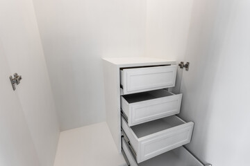 drawer with white wood closet  cabinets in bedroom
