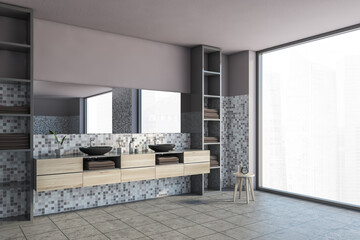 Grey and pink bathroom with black sinks, grey tiled floor and window