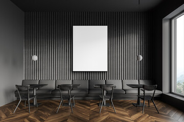Dark gray restaurant interior with tables, sofa and poster
