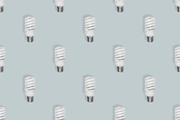 Light bulb seamless pattern. Lighting bulbs on a gray background.