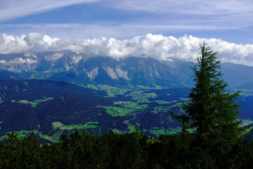 Fototapeta premium high mountains with dense clouds while hiking in the summer