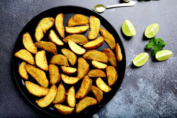 Healthy vegan diet meal- baked potato wedges.