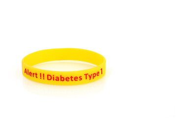 Diabetes type 1 alert wristband in yellow rubber silicone with red type on white background.